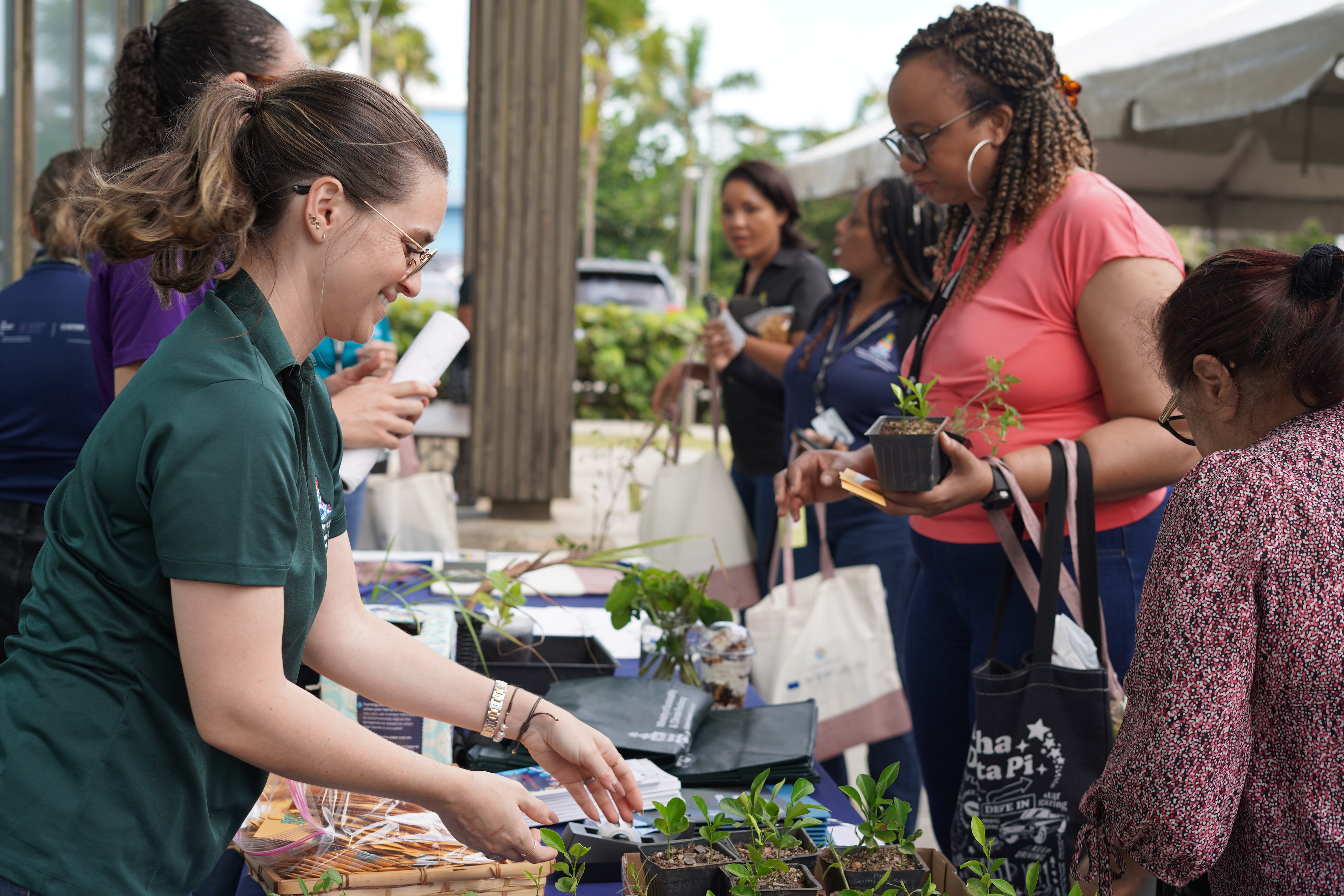 Civil Servants from the ministry of sustainability displaying products and informational items on sustainability efforts in the cayman islands.