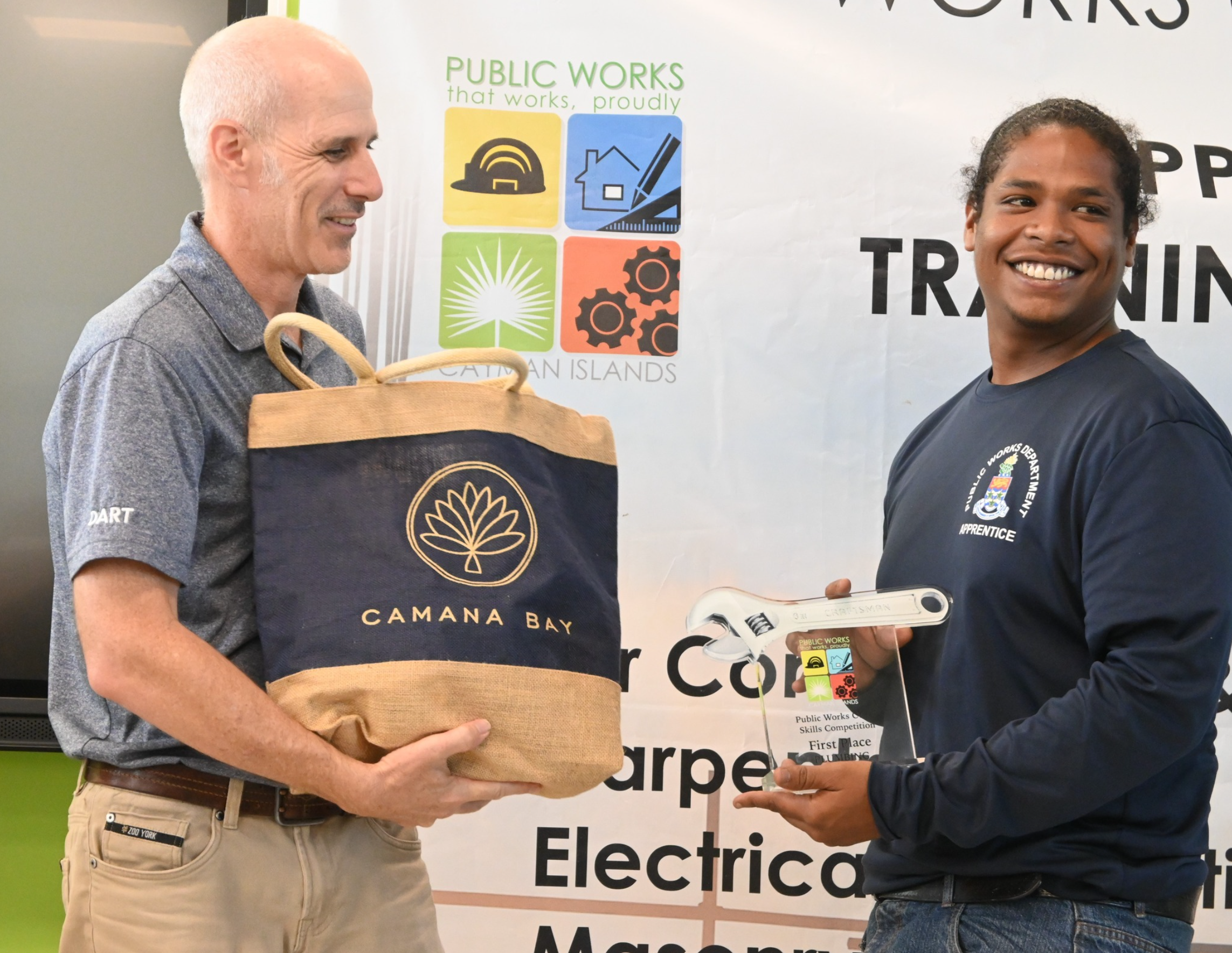 Cayman Islands Public Works Department Apprentice Accepts award for completion.