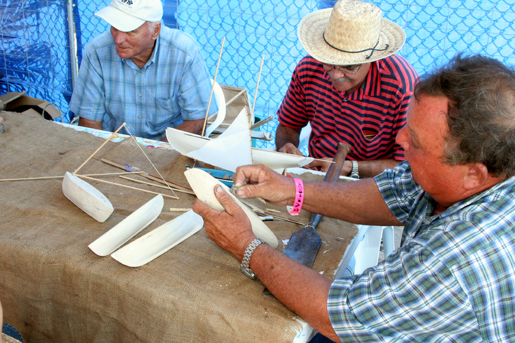 Caymanian men demonstrate the art of boatmaking