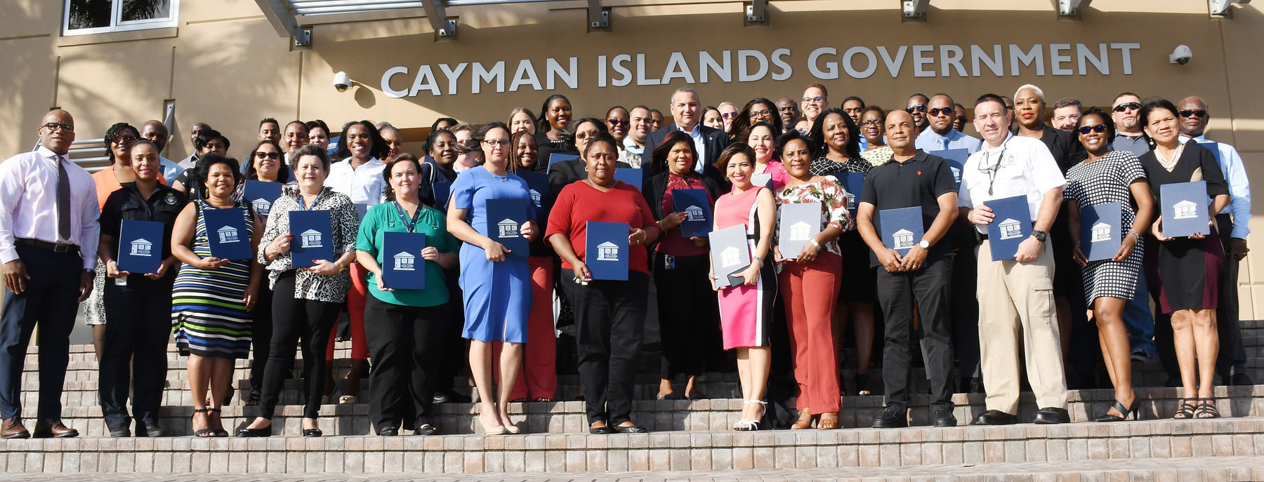 Cayman Islands Civil Servants pose for a picture on the steps of the Government Administration Building