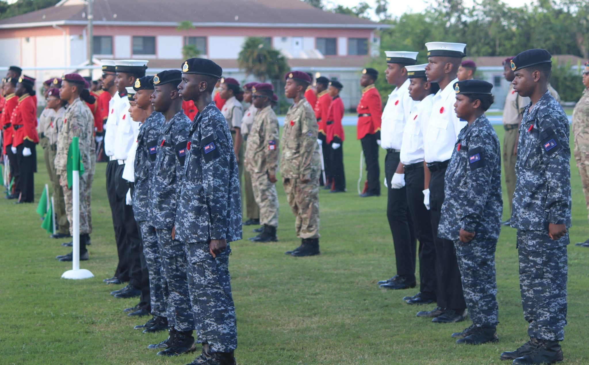 Various Cayman Islands Cadet Corps stand at attention