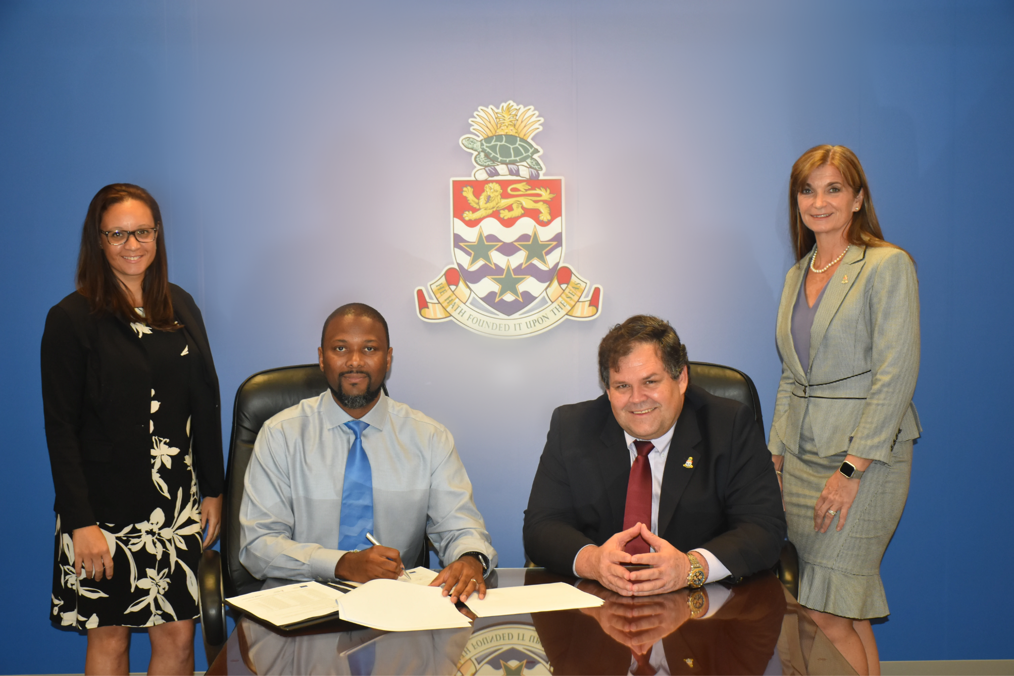 High Ranking Civil Servant and previous premier Wayne Panton pose for a picture at the signing of contracts for two RESEMBID grants on behalf of the Cayman Islands Government to make housing more affordable and energy effiecent.